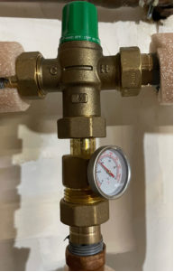 a thermostatic mixing valve attached to a water heater